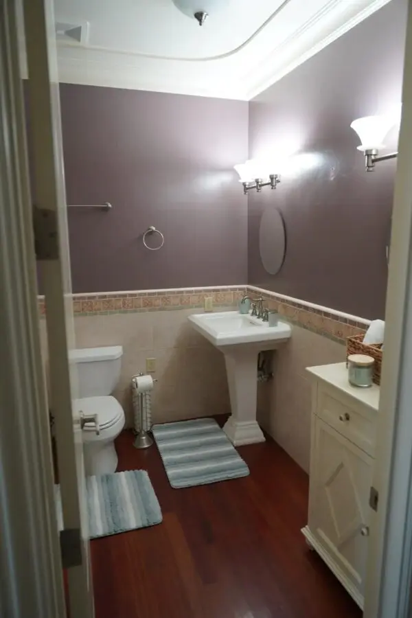 A Bathroom Space With Violet Color Walls